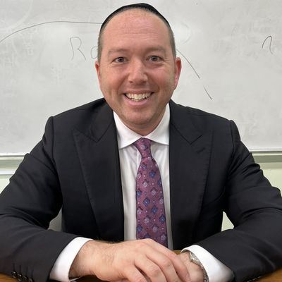 Rabbi Ikey Tawil smiling at a desk